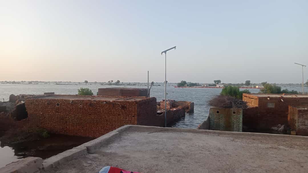 View of Village Umeed Ali Junejo submerged under flood water in Qambar Shahdadkot district, in 2022 flood in Pakistan. A villager in the first picture showed, stading flood water. All houses crack down due to heavy rainfall and flood water.
