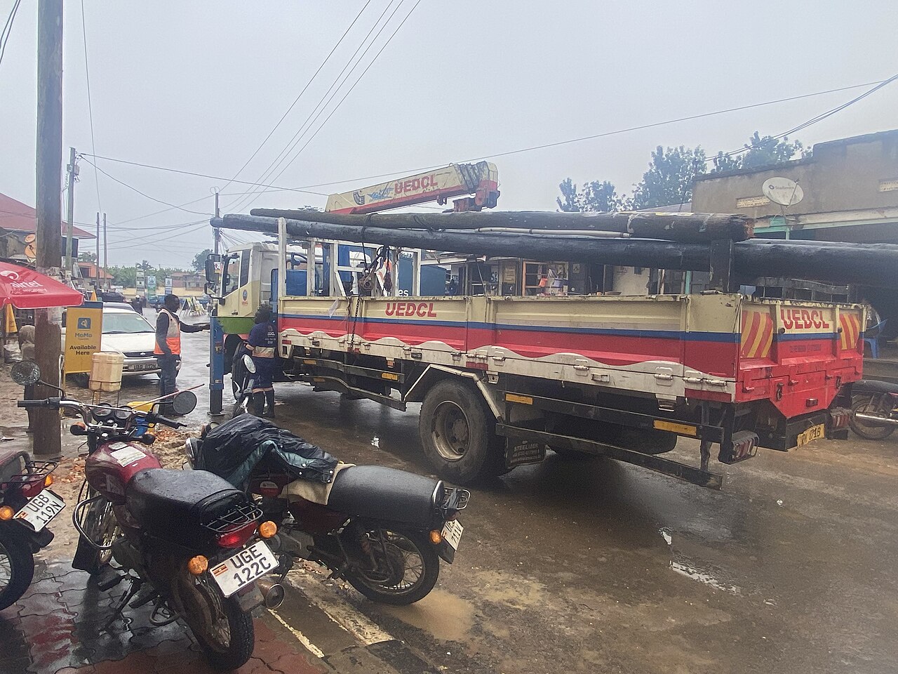 UEDCL (Uganda Electricity Distribution Company Limited) staff replacing an electricity pole in Bushenyi