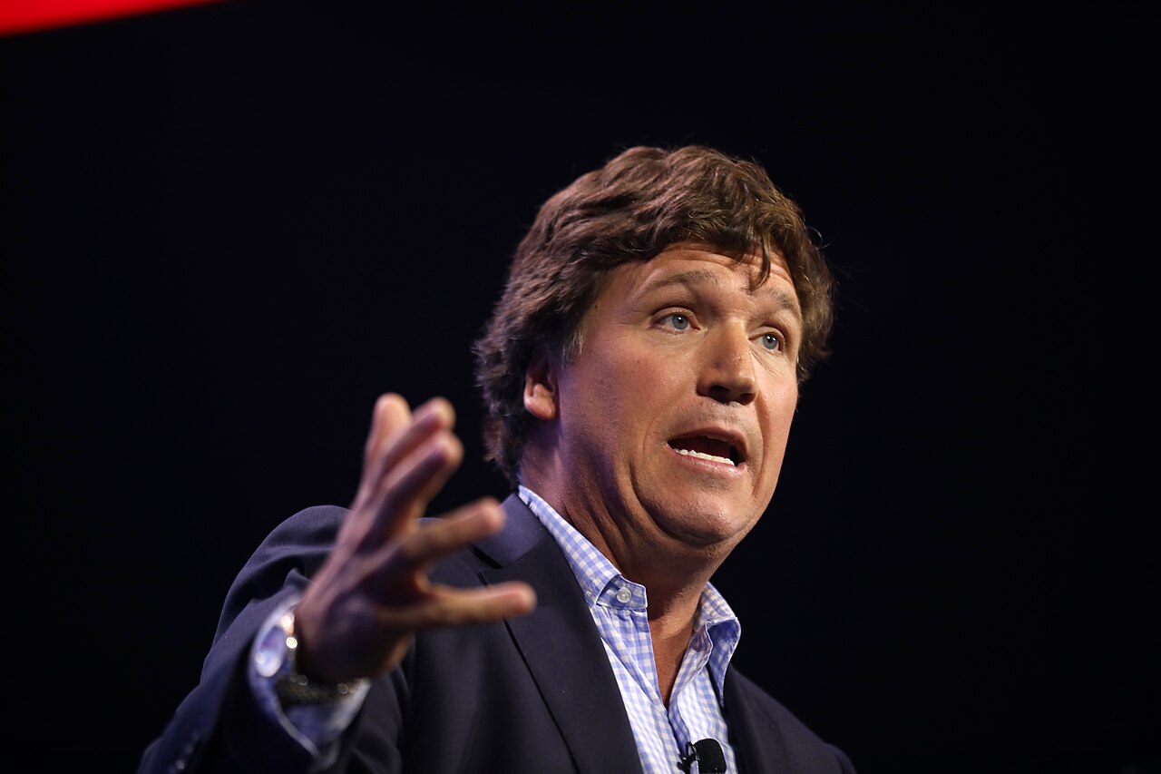 Tucker Carlson speaking with attendees at the 2023 Turning Point Action Conference at the Palm Beach County Convention Center in West Palm Beach, Florida.