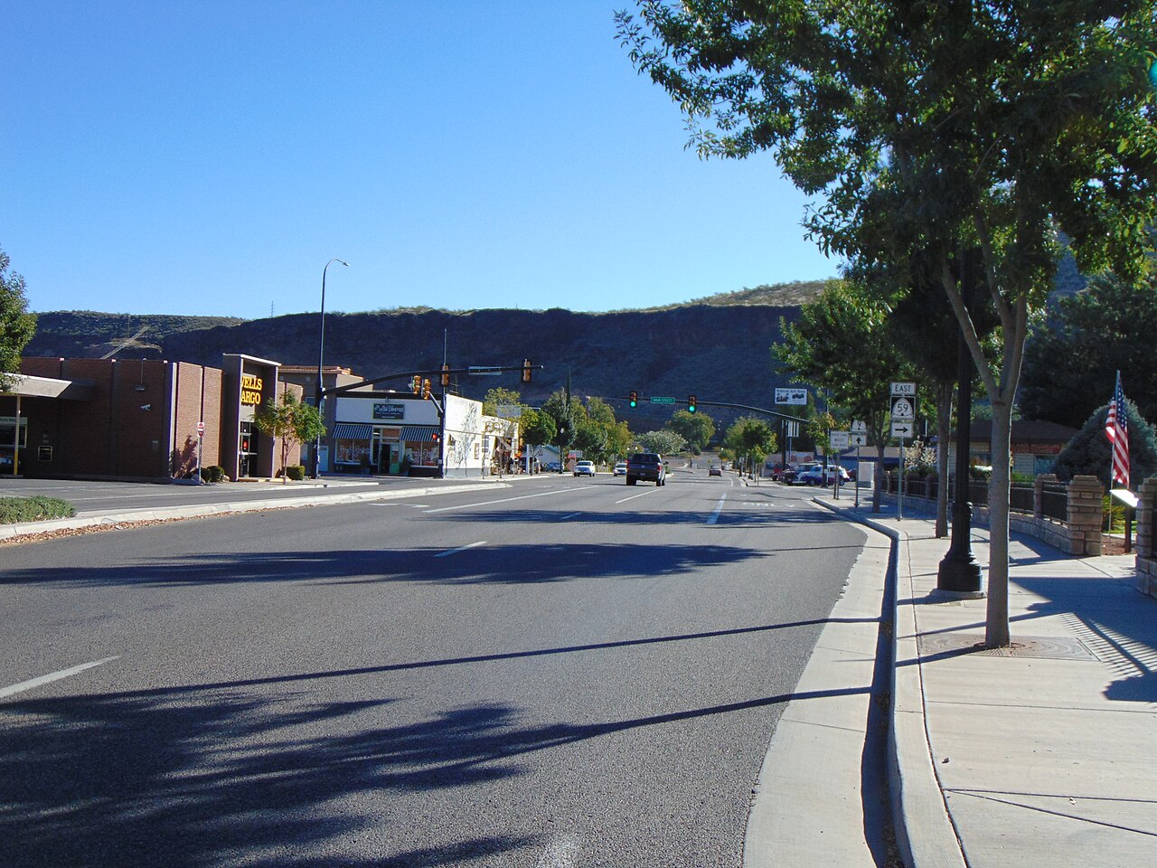 Looking east along East State Street (Utah State Route 9) at its junction with Utah State Route 59 (Main Street) in eastern Hurricane, Utah, with the Hurricane Cliffs in the background, October 2016. The intersection is the northern terminu