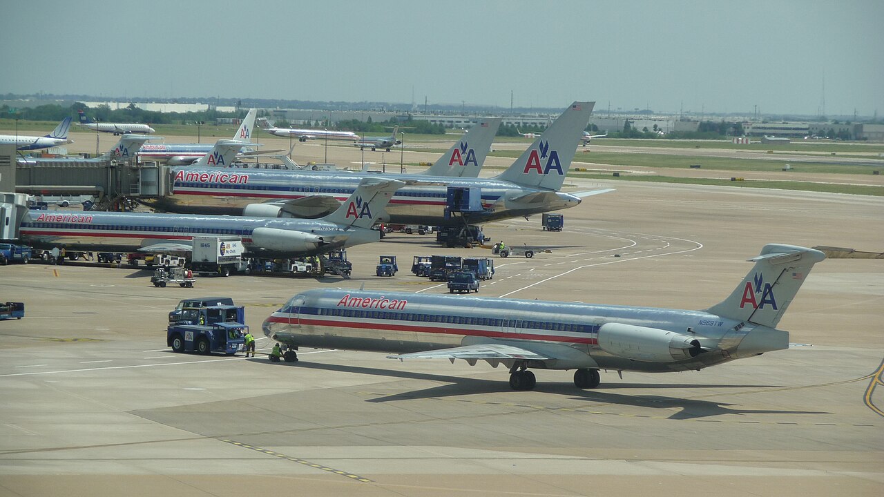 Various American Airlines Aircraft parked and taxiing at DFW Airport.