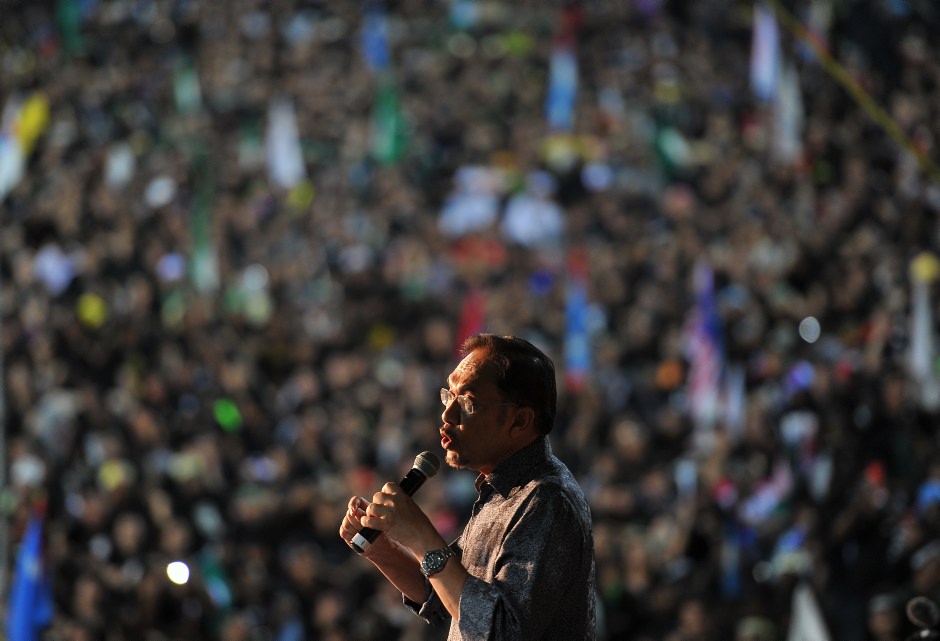 Malaysian opposition leader Anwar Ibrahim speaks during a rally dressed in mourning black gathered to denounce elections which they claim were stolen through fraud by the coalition that has ruled for 56 years. in Penang May 11 2013. Pix Fir