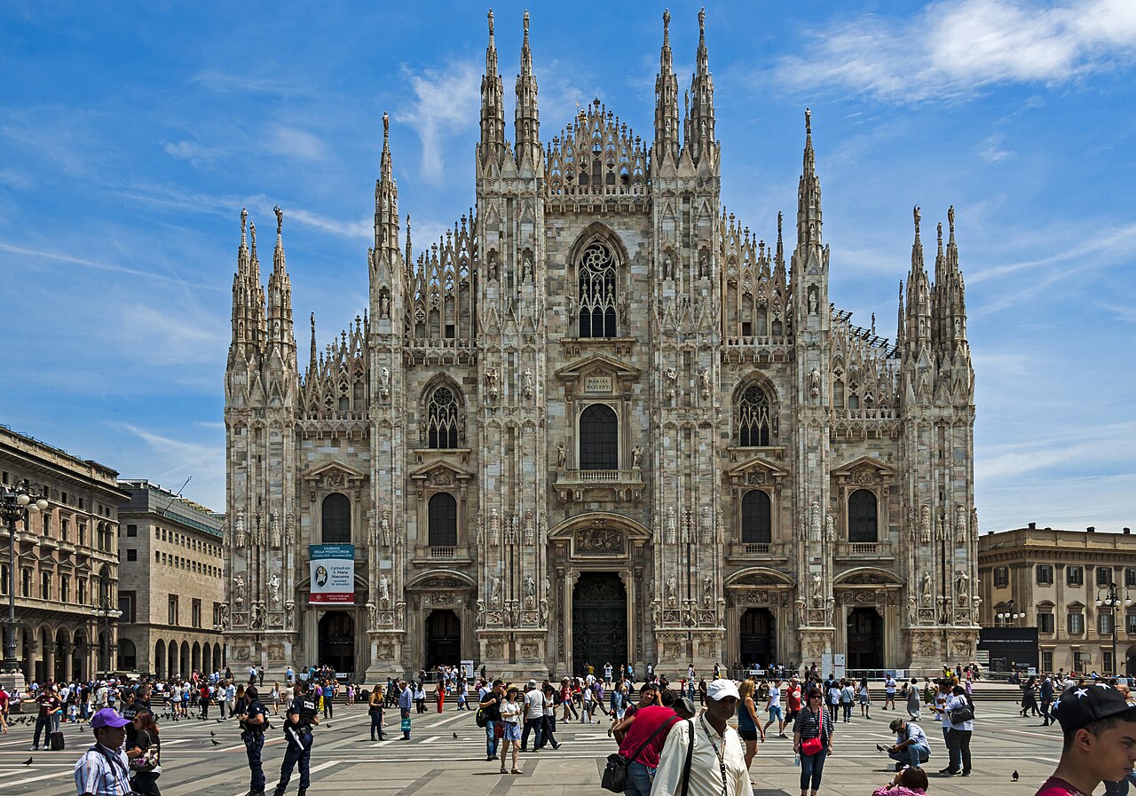 The Duomo of Milan seen from the Piazza , with tourists around on a typical summer day