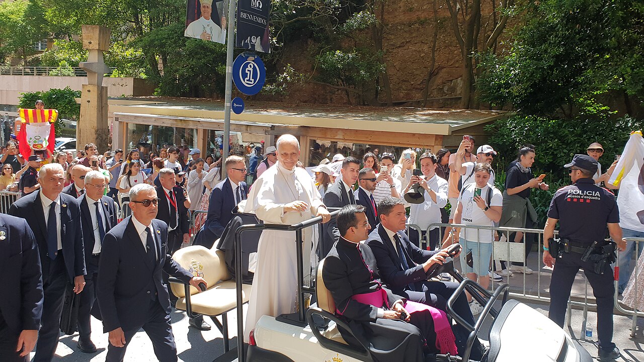 Pope Leo XIV raising his hand to greet pilgrims, volunteers and Mossos d'Esquadra officers at the Abbey of Santa Maria de Montserrat, 10 June 2026.